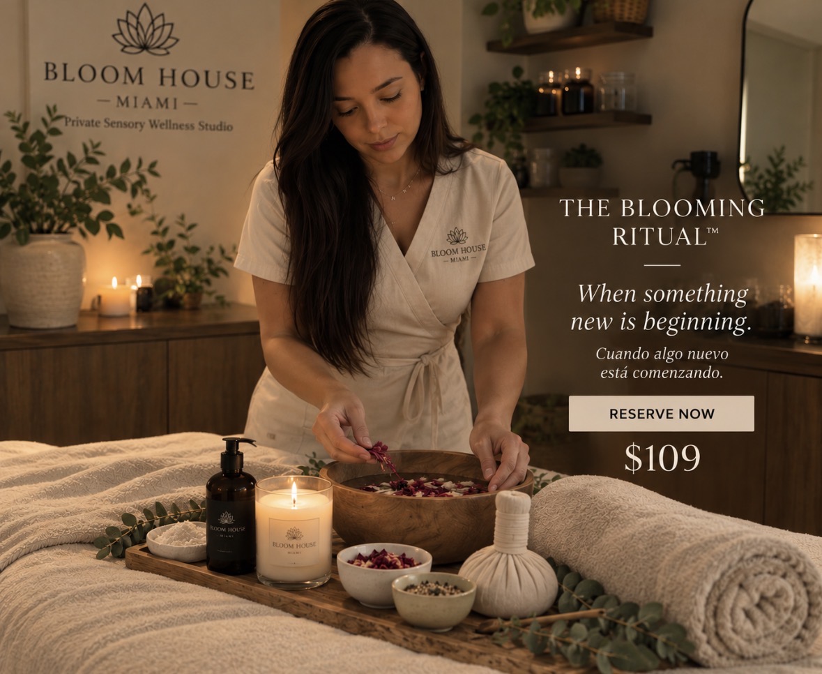 Bloom House therapist preparing The Blooming Ritual with flowers, botanicals, warm towels and candlelight